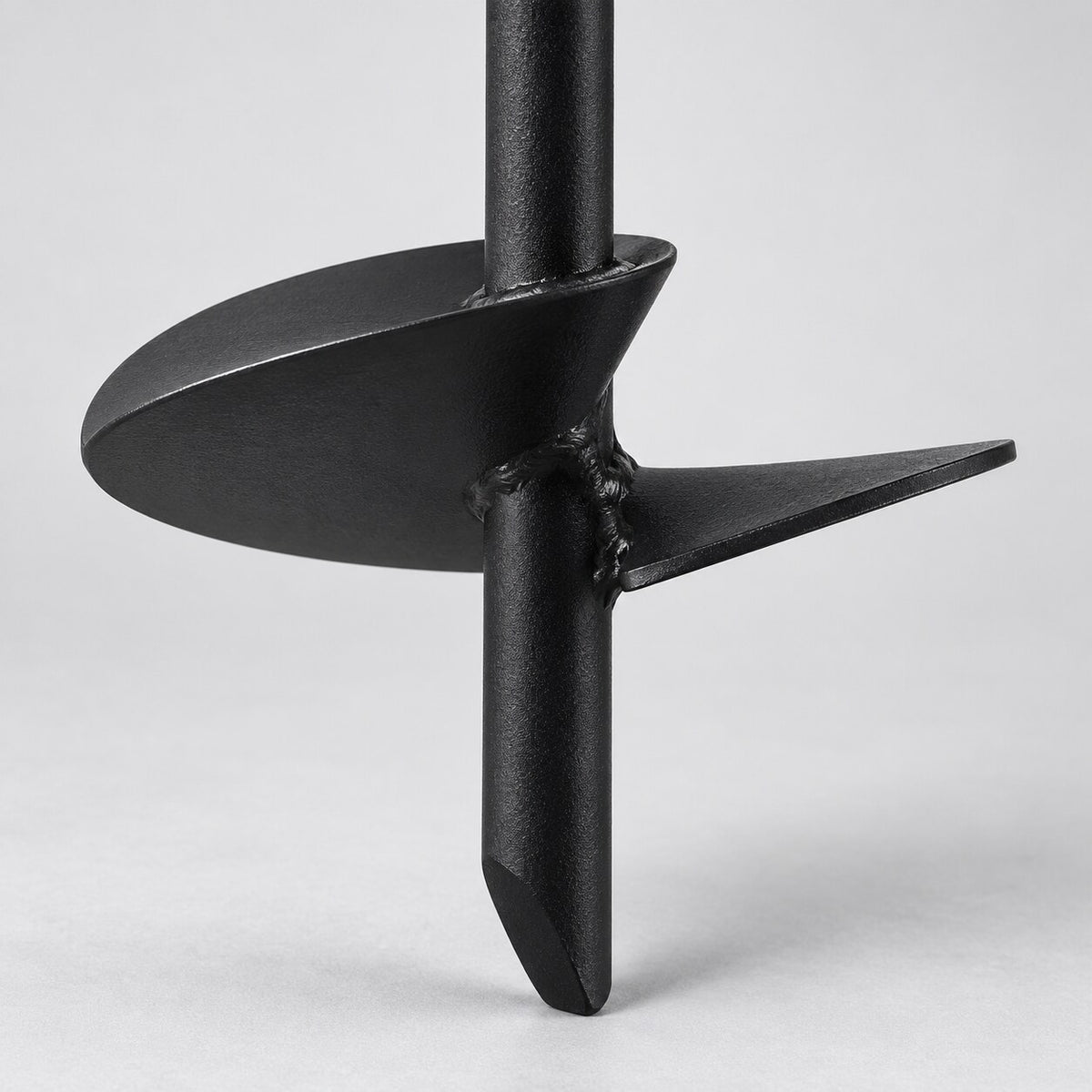 Close-up of the black metal spiral blade and ground anchor tip